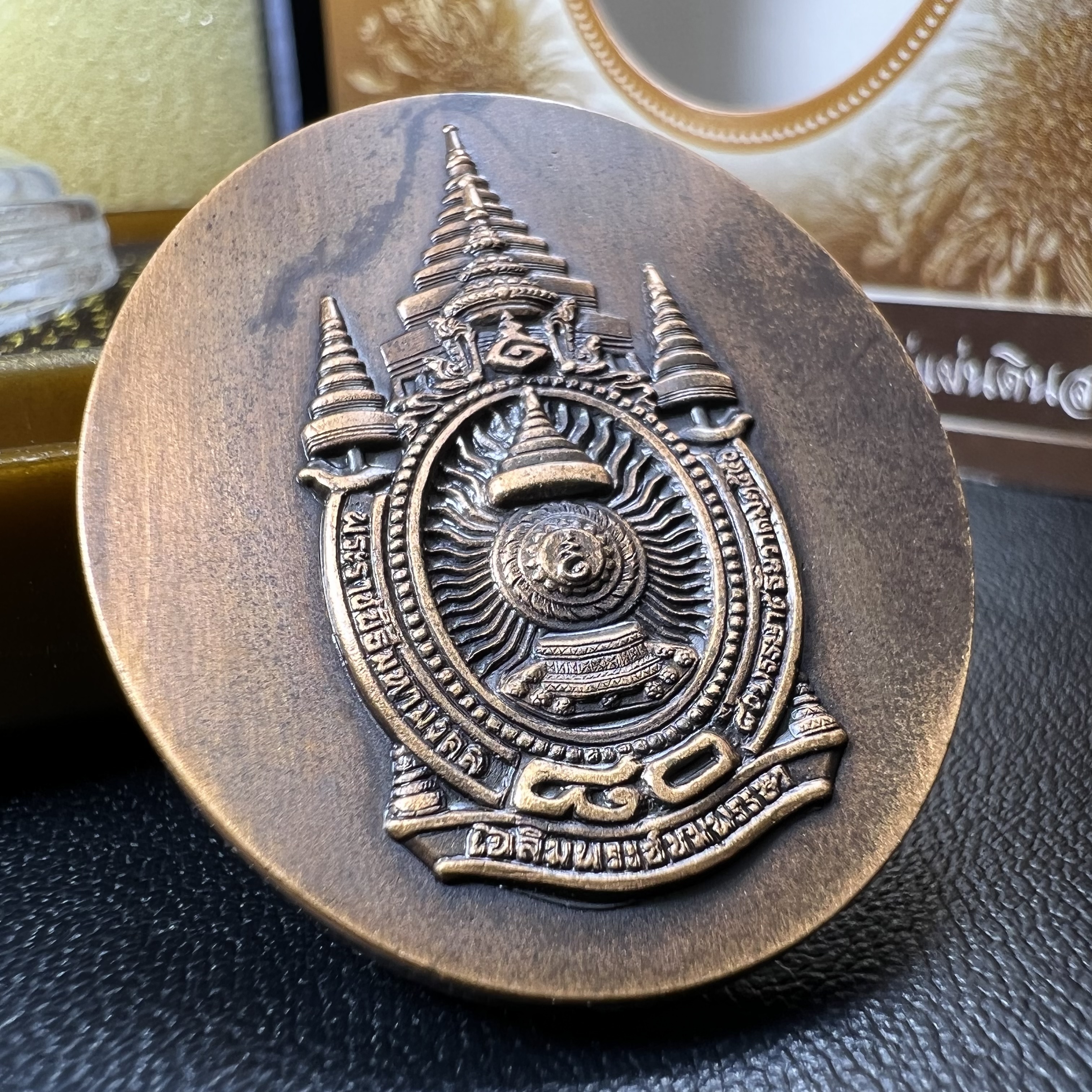 เหรียญรูปหล่อพระบาทสมเด็จพระเจ้าอยู่หัว ในหลวงทรงงาน “รุ่นเย็นศิระเพราะพระบริบาล 80พรรษา มหากษัตริย์คู่แผ่นดินสยาม” พ.ศ.2550 เนื้อทองแดงรมดำ(ขนาด 27*35 มม.)พร้อมกล่องบรรจุเดิมครบ