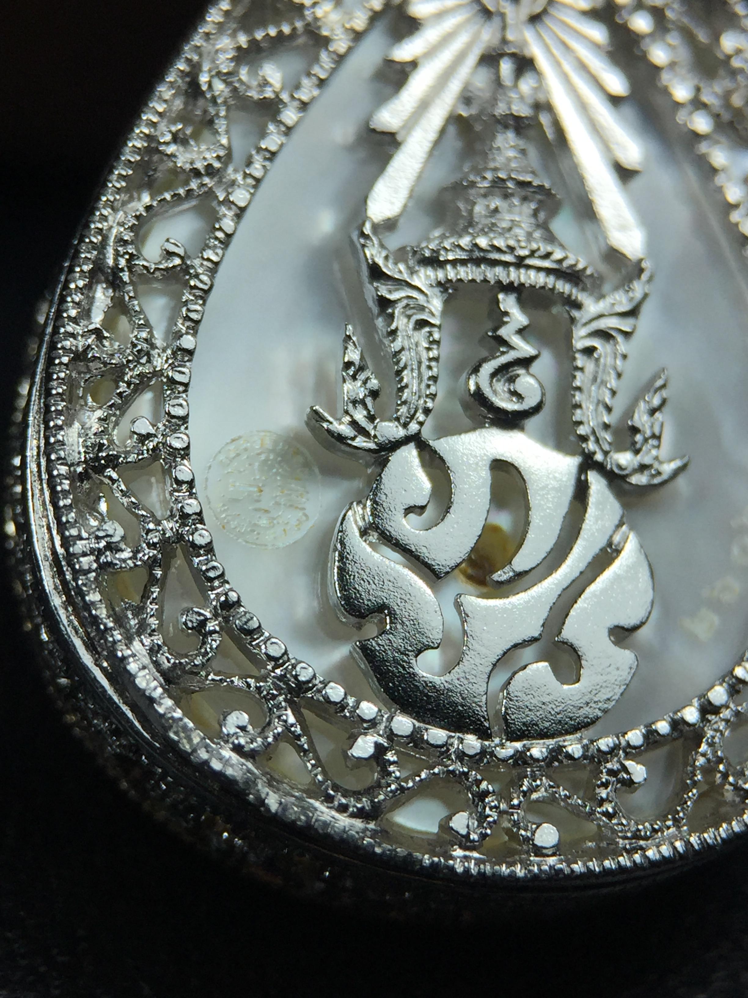 พระพุทธชินราช ภปร. โครงการ "เพราะแผ่นดินนี้ คือ แผ่นดินเกิด" ปี2548(รุ่นแรก) เหรียญทรงหยดน้ำ ขนาด 21 x 31 มม. เนื้อเงินสามกษัตริย์ องค์พระชุบสามกษัตริย์ ล้อมด้วยกรอบเงินชุบทองคำขาวสลักเสลาเป็นลวดลายละเอียดอ่อน ส่วนพื้นองค์พระเป็นเปลือกหอยมุข