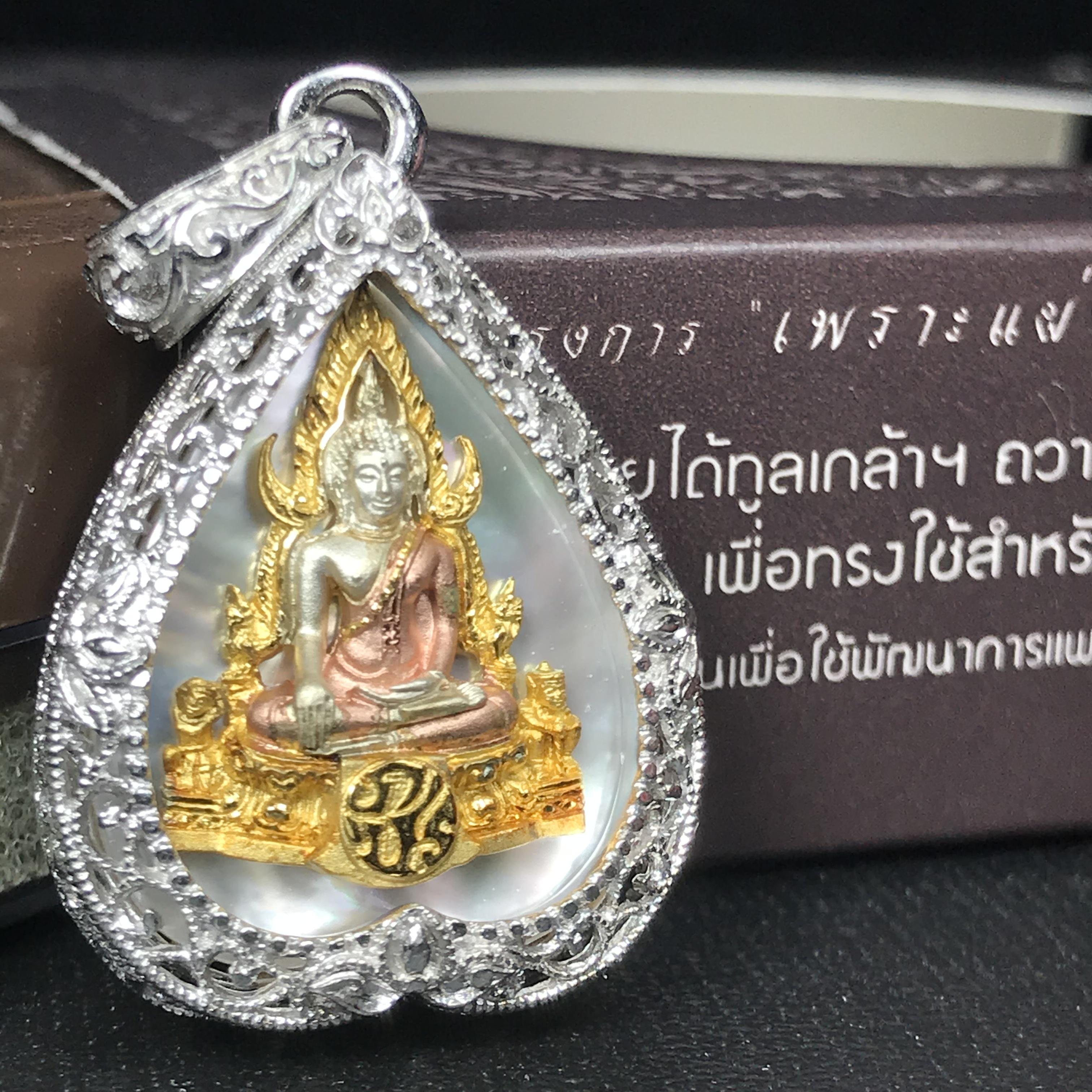 พระพุทธชินราช ภปร. โครงการ "เพราะแผ่นดินนี้ คือ แผ่นดินเกิด" ปี2548(รุ่นแรก) เหรียญทรงใบโพธิ์ ขนาด 21 x 29 มม. เนื้อเงินสามกษัตริย์ องค์พระชุบสามกษัตริย์ ล้อมด้วยกรอบเงินชุบทองคำขาวสลักเสลาเป็นลวดลายละเอียดอ่อน ส่วนพื้นองค์พระเป็นเปลือกหอยมุข