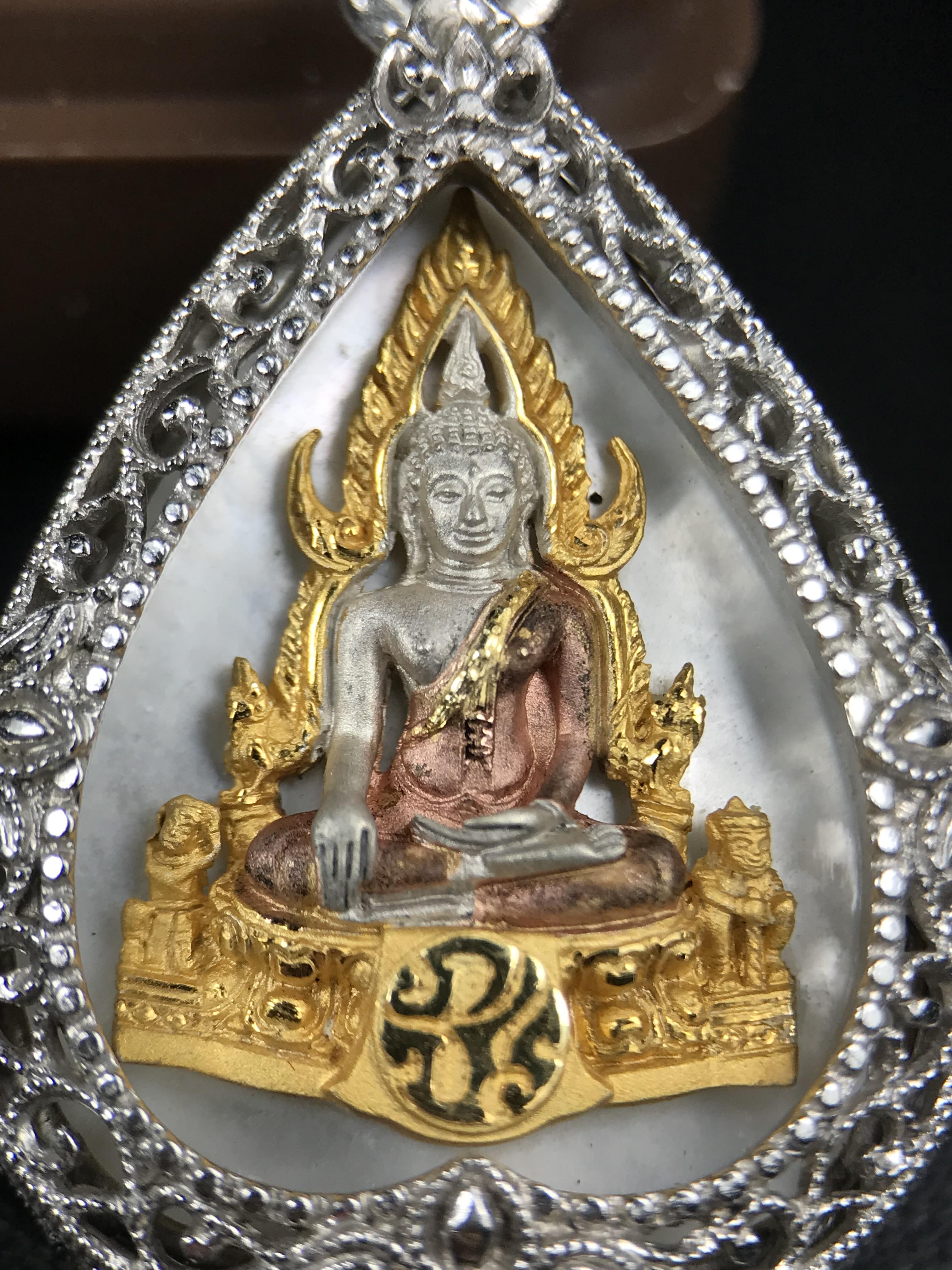 พระพุทธชินราช ภปร. โครงการ "เพราะแผ่นดินนี้ คือ แผ่นดินเกิด" ปี 2548(รุ่นแรก) เหรียญทรงใบโพธิ์ ขนาด 21 x 29 มม. เนื้อเงินสามกษัตริย์ องค์พระชุบสามกษัตริย์ ล้อมด้วยกรอบเงินชุบทองคำขาวสลักเสลาเป็นลวดลายละเอียดอ่อน ส่วนพื้นองค์พระเป็นเปลือกหอยมุข