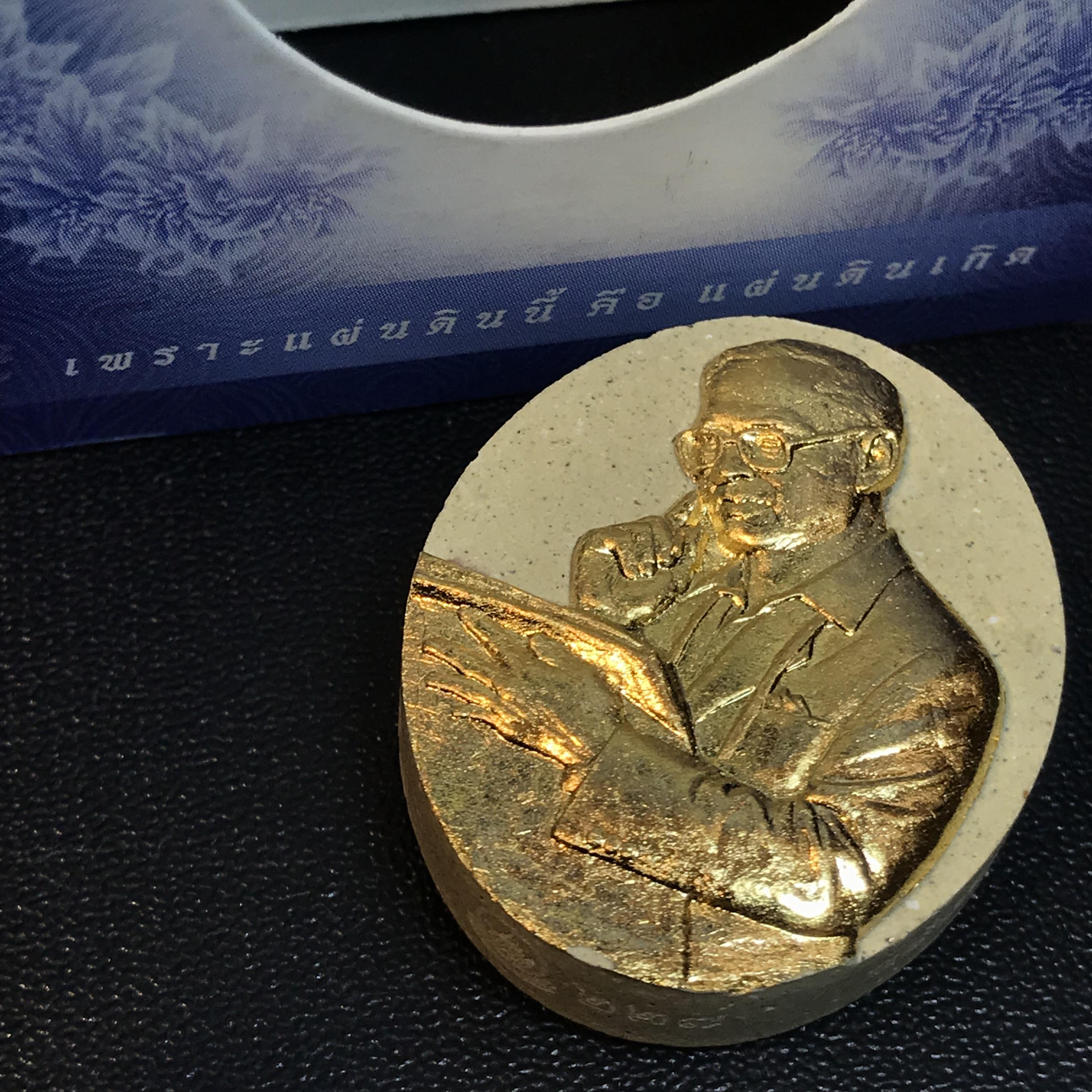 รูปหล่อพระบาทสมเด็จพระเจ้าอยู่หัว(ทรงงาน) ภปร. โครงการ เพราะแผ่นดินนี้คือแผ่นดินเกิด ปี2551 เนื้อผง ด้านหน้าปิดทอง หลัง ภ.ป.ร. ปิดทอง (มวลสารพระราชทานเส้นพระเจ้า (เส้นผม) ของพระบาทสมเด็จพระเจ้าอยู่หัวรัชกาลที่9