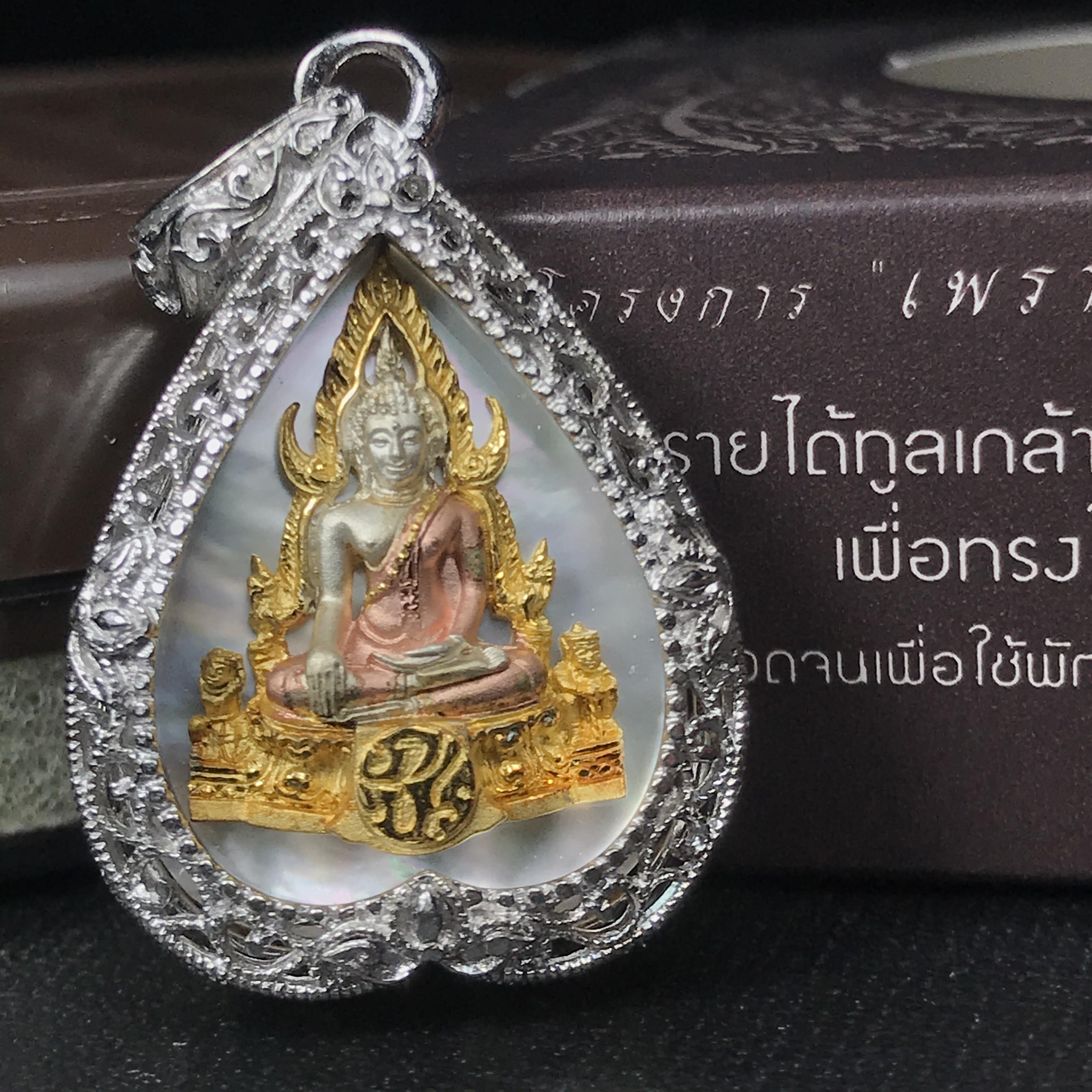 พระพุทธชินราช ภปร. โครงการ "เพราะแผ่นดินนี้ คือ แผ่นดินเกิด" ปี2548(รุ่นแรก) เหรียญทรงใบโพธิ์ ขนาด 21 x 29 มม. เนื้อเงินสามกษัตริย์ องค์พระชุบสามกษัตริย์ ล้อมด้วยกรอบเงินชุบทองคำขาวสลักเสลาเป็นลวดลายละเอียดอ่อน ส่วนพื้นองค์พระเป็นเปลือกหอยมุข
