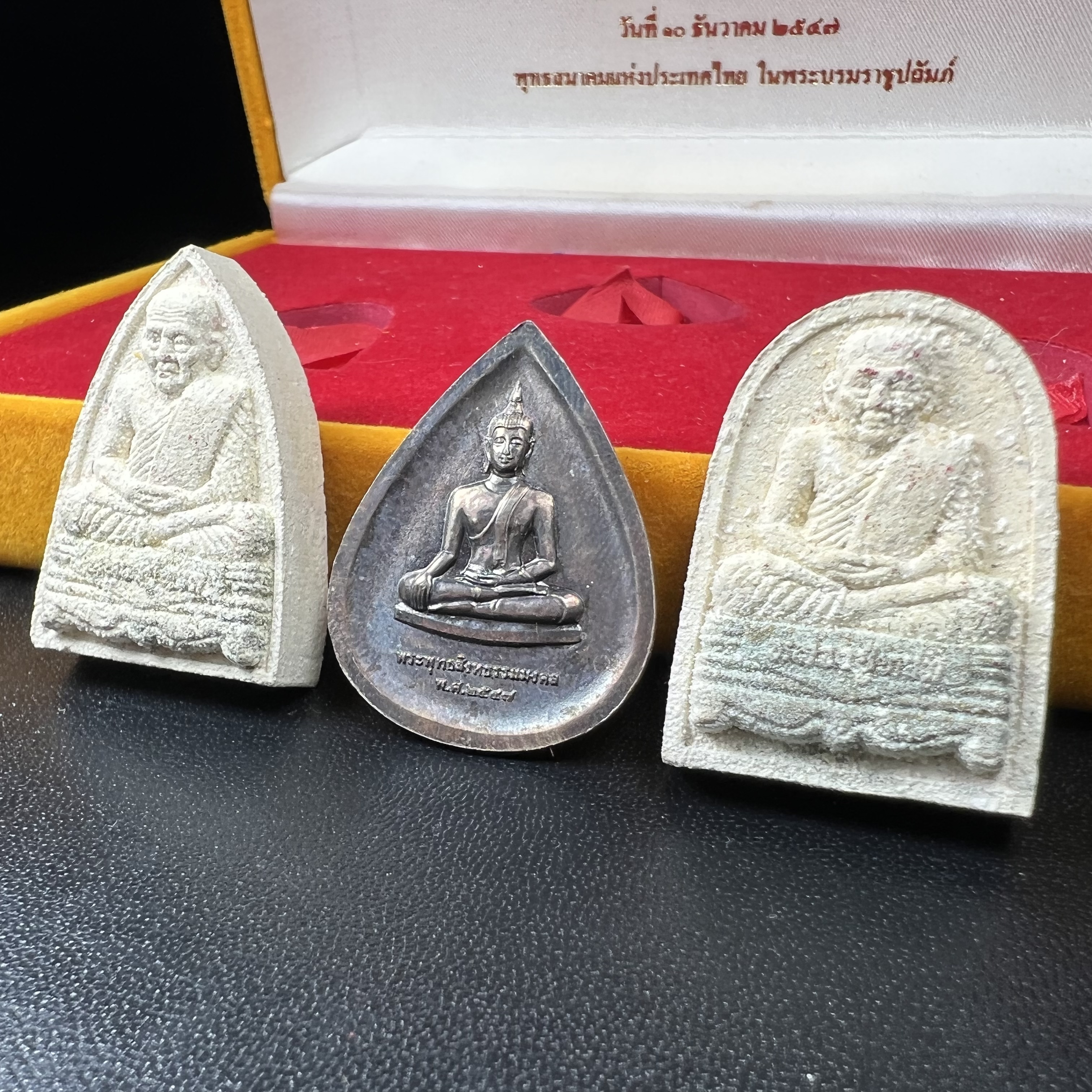 พระหลวงปู่ทวด ภปร.ปี2547 (เนื้อพิเศษกรรมการ)ทรงกลีบบัวและทรงกลีบขนุน เนื้อผงสมเด็จฯ(โรยผงตะไบ ชนวนเก่า) พร้อมเหรียญพระพุทธสิหธรรมมงคล ภปร. ทรงหยดน้ำ เนื้อเงินแท้ กล่องบรรจุเดิมครบ(1ชุด 3 องค์)(หายาก)