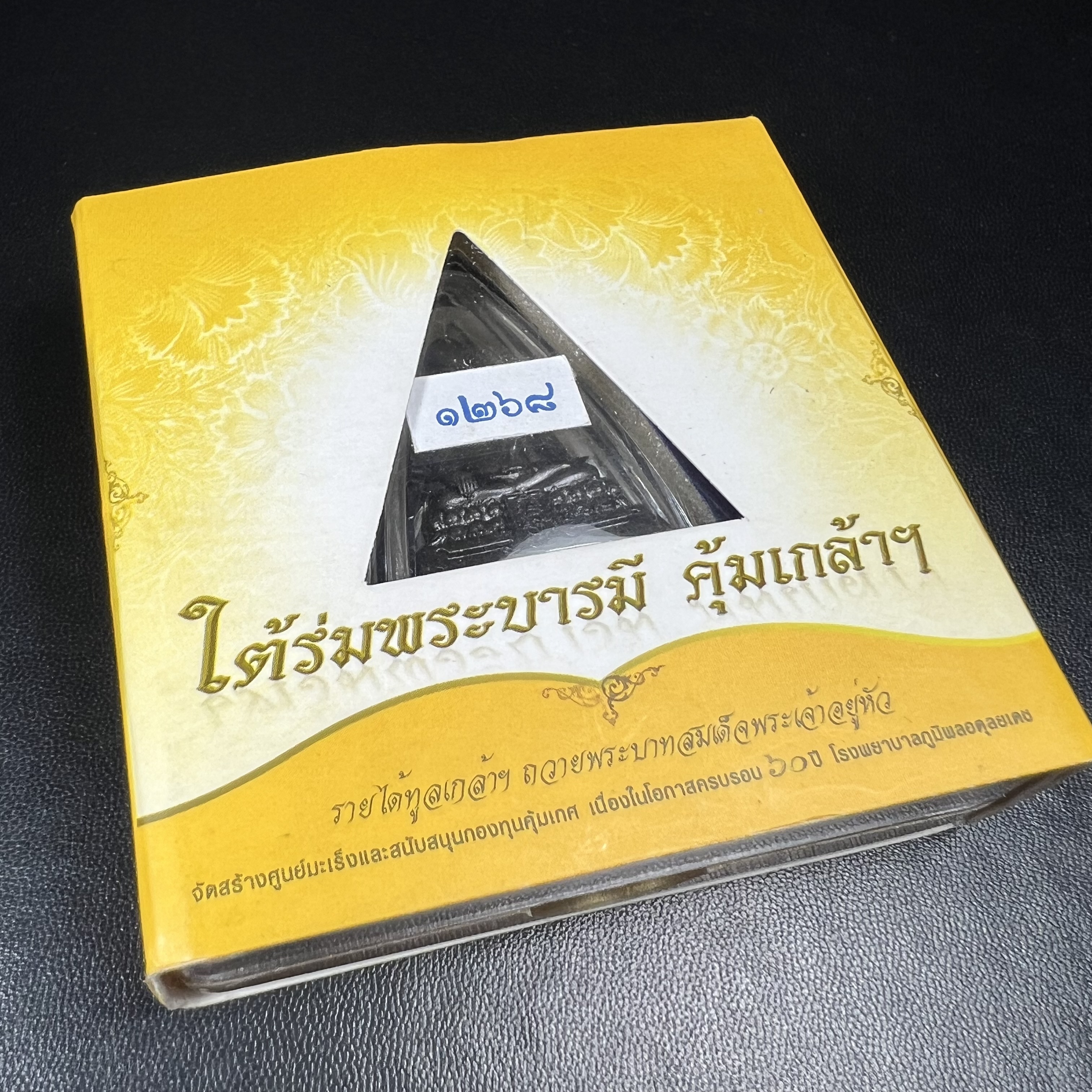พระพุทธรูปคุ้มเกล้าฯ ภปร.(ใต้ร่มพระบารมี คุ้มเกล้า) 60ปี โรงพยาบาลภูมิพลฯ พ.ศ.2552 เนื้อนวโลหะ รมดำ(พิมพ์ใหญ่ขนาด 35.5*24 มม.)สภาพสวยเดิมพร้อมกล่องบรรจุเดิม ตอกโค๊ดหมายเลขกำกับ